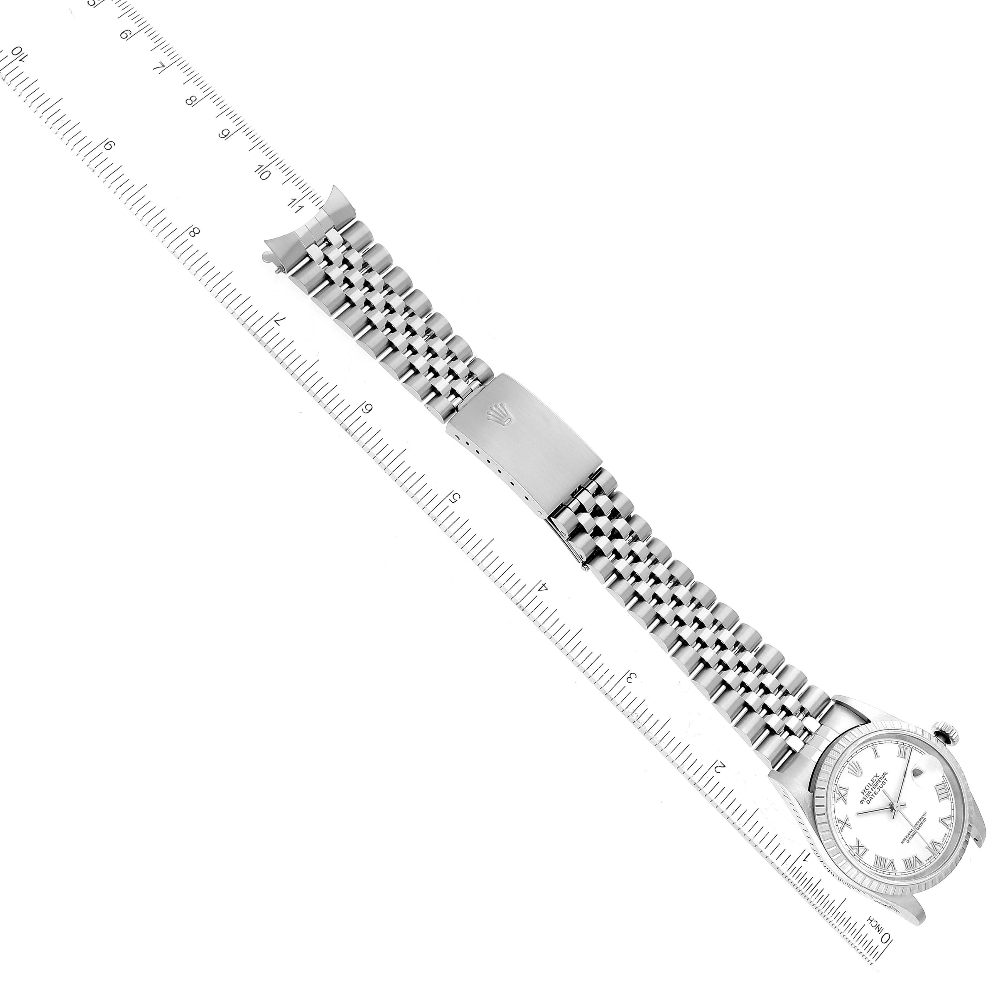 The image shows the Rolex Datejust 16220 Men's Stainless Steel White Dial 16220 Men's Stainless Steel White Dial watch laid flat alongside a ruler, highlighting the watch face and full bracelet.