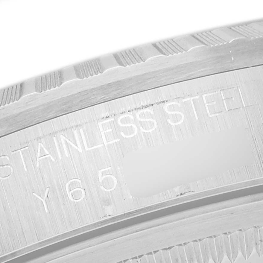 This image shows a close-up angle of the stainless steel bezel and engraved inscription on a Rolex Datejust 16220 Men's Stainless Steel White Dial 16220 Men's Stainless Steel White Dial watch.
