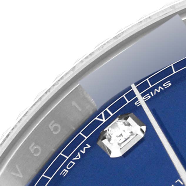 This close-up image of a Rolex Datejust 41 126334 Men
s Stainless Steel Blue Dial 126334 Men
s Stainless Steel Blue Dial watch shows part of the blue dial with a diamond marker and a portion of the flange with an engraved serial number.