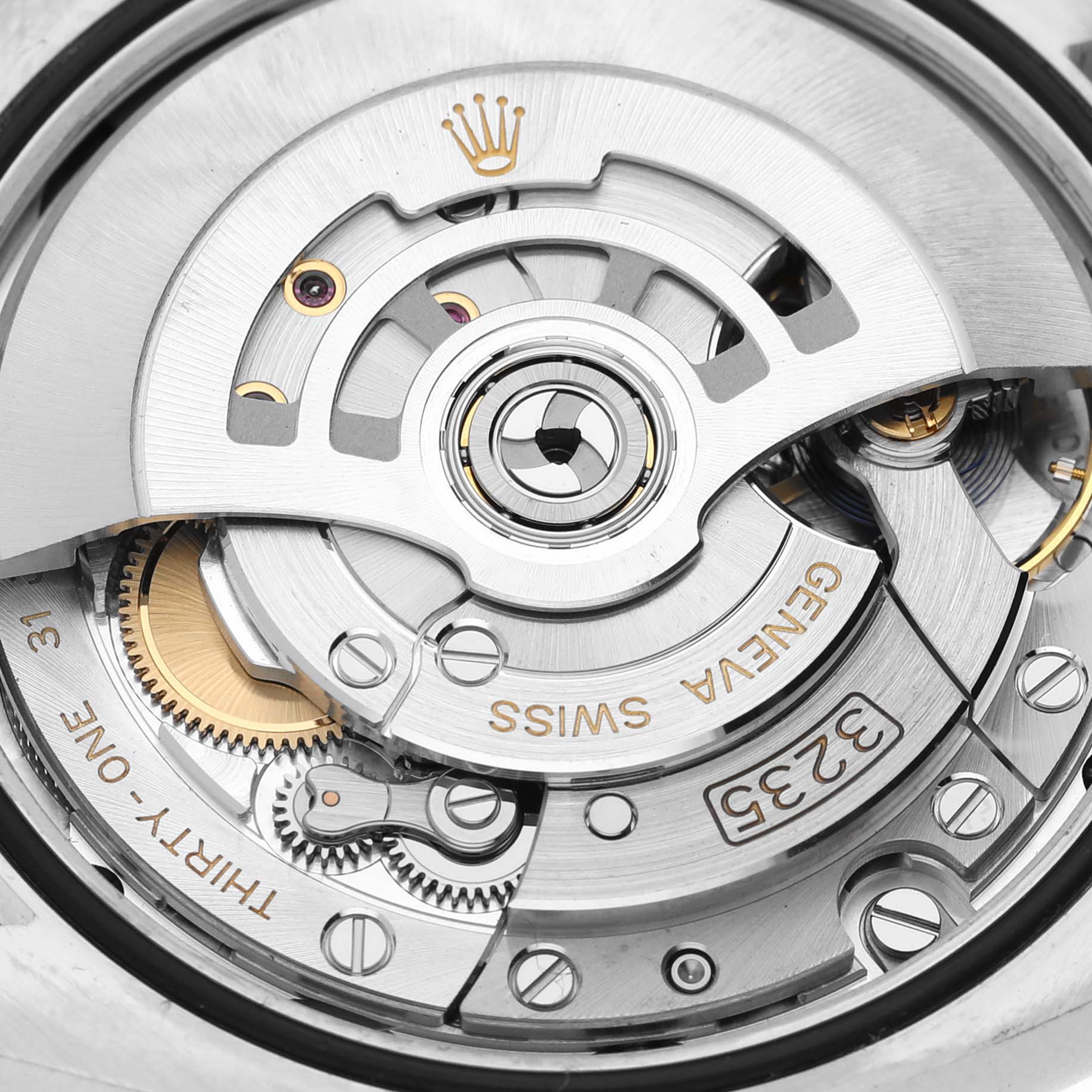 The close-up image shows the intricate inner mechanism of a Rolex Datejust 126231 Men's Steel and Gold (two tone) Brown Dial 126231 Men's Steel and Gold (two tone) Brown Dial watch, highlighting the movement and Rolex branding.