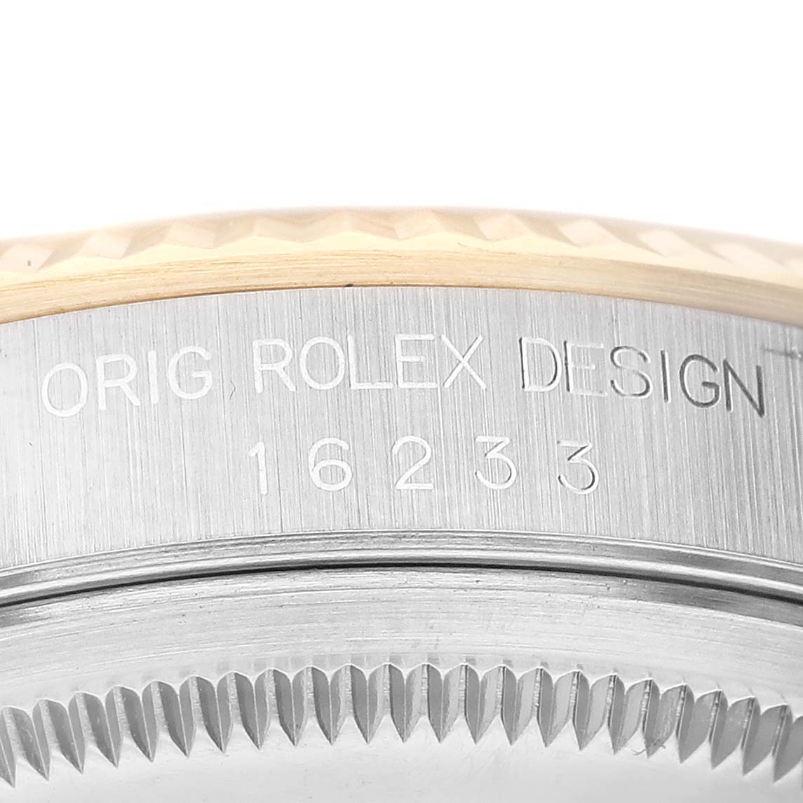 The image shows a close-up of the case side of a Rolex Datejust 16233 Men's Steel and Gold (two tone) Champagne Dial 16233 Men's Steel and Gold (two tone) Champagne Dial model watch, featuring its engraved design and model number.