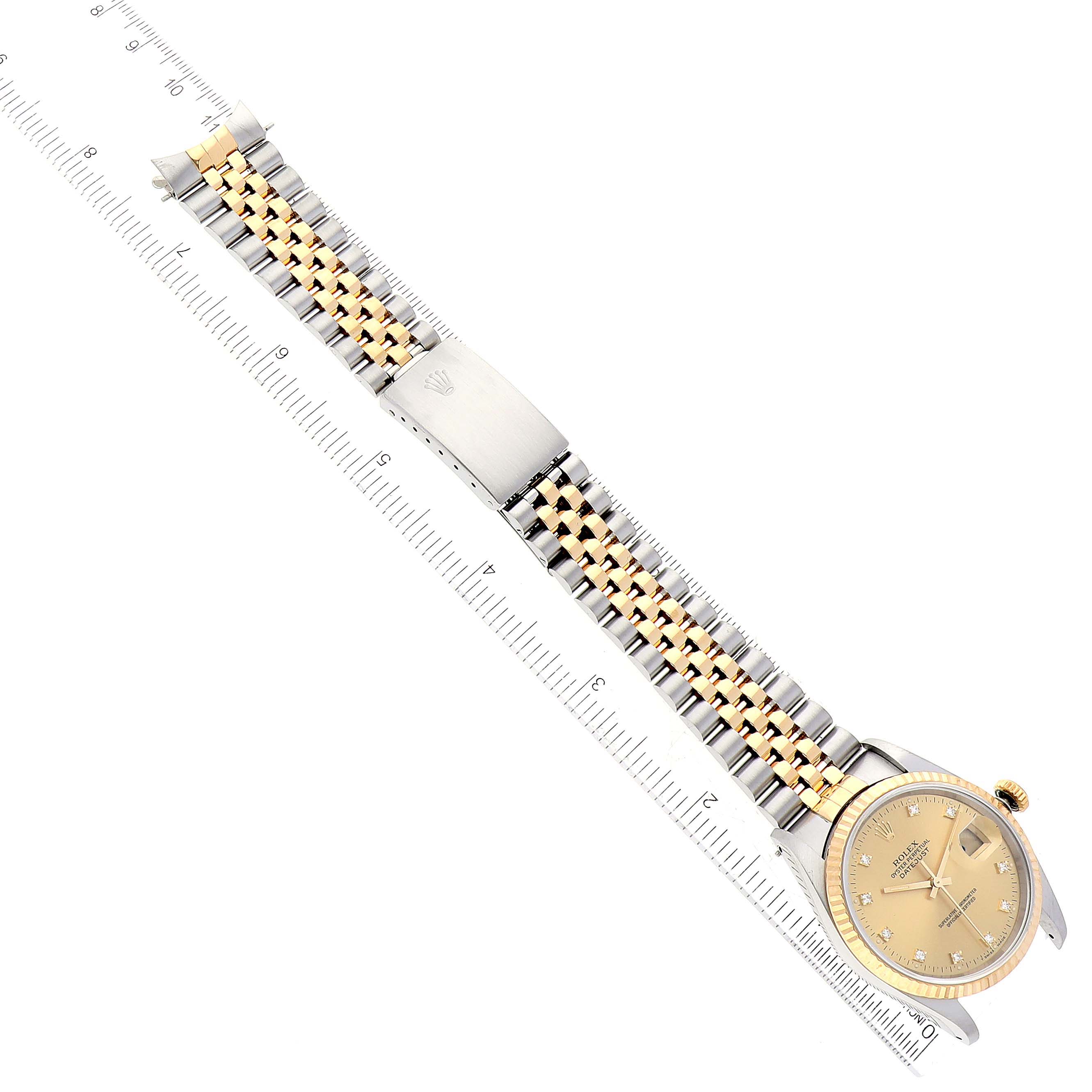 The image shows a Rolex Datejust 16233 Men's Steel and Gold (two tone) Champagne Dial 16233 Men's Steel and Gold (two tone) Champagne Dial watch laid flat, displaying the full face, bracelet, and clasp, with a ruler for scale.