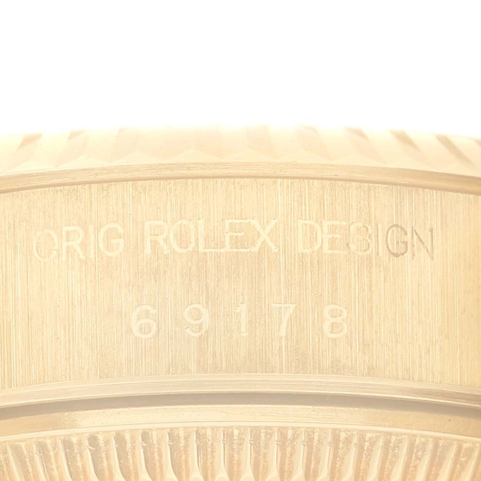 The image shows the engraved side of the case of a Rolex President 69178G Women
s Yellow Gold Champagne Dial 69178G Women
s Yellow Gold Champagne Dial model, displaying the reference number and design inscription.