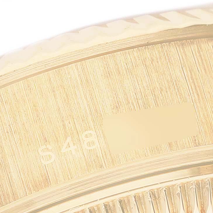 This close-up angle shows the serial number and part of the fluted bezel of the Rolex President 69178GNR Women's Yellow Gold Mother of Pearl Dial 69178GNR Women's Yellow Gold Mother of Pearl Dial watch.