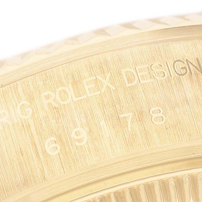 This image shows a close-up of the engraved bezel of a Rolex President 69178GNR Women's Yellow Gold Mother of Pearl Dial 69178GNR Women's Yellow Gold Mother of Pearl Dial model watch.