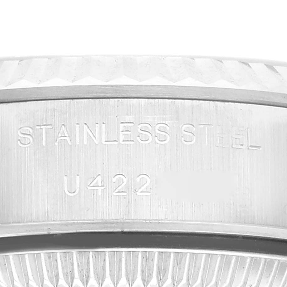 This image shows a close-up of the stainless steel case and bezel of a Rolex Datejust 69174 Women's Stainless Steel Blue Dial 69174 Women's Stainless Steel Blue Dial watch, including part of the serial number.