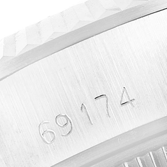 This is a close-up image showing the serial number engraving on the side of the casing of a Rolex Datejust 69174 Women's Stainless Steel Blue Dial 69174 Women's Stainless Steel Blue Dial watch.