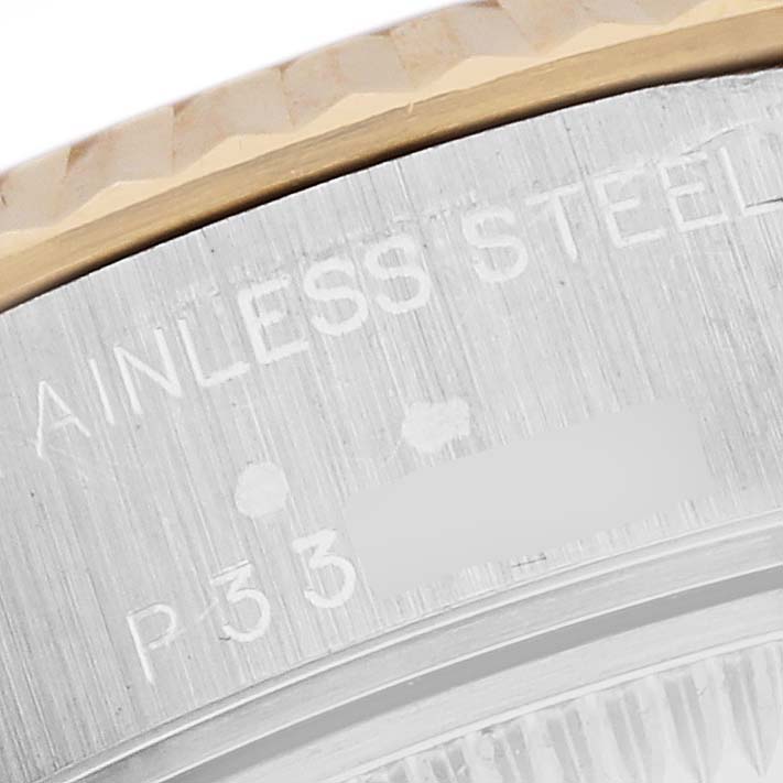 This close-up of the Rolex Datejust 79173 Women's Steel and Gold (two tone) Champagne Dial 79173 Women's Steel and Gold (two tone) Champagne Dial shows the stainless steel and gold bezel, with engravings partially visible.