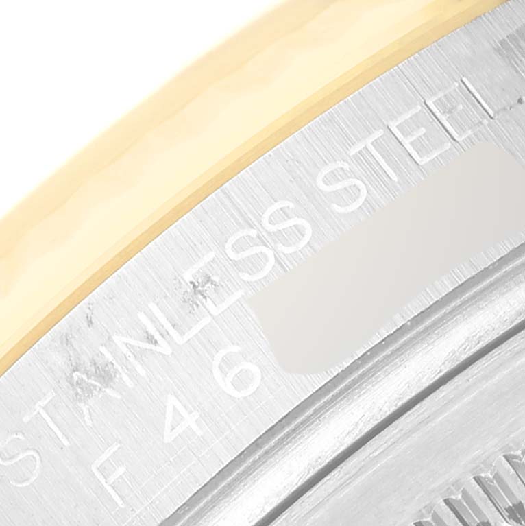This close-up shows part of the case back and bezel of the Rolex Datejust 116233 Men's Steel and Gold (two tone) Champagne Dial 116233 Men's Steel and Gold (two tone) Champagne Dial, with "STAINLESS STEEL" engraved.