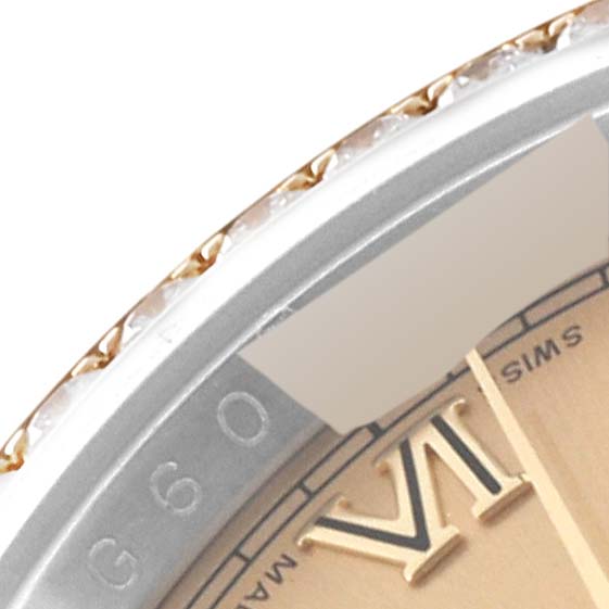 This close-up image of a Rolex Datejust 116243 Men's Steel and Gold (two tone) Champagne Dial 116243 Men's Steel and Gold (two tone) Champagne Dial shows part of the dial, bezel, and Roman numeral VI.