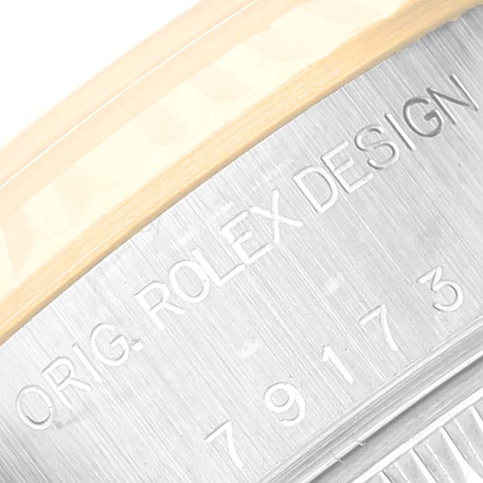 This close-up image shows the engraved text on the caseback of a Rolex Datejust 79173NGR Women's Steel and Gold (two tone) Mother of Pearl Dial 79173NGR Women's Steel and Gold (two tone) Mother of Pearl Dial watch.