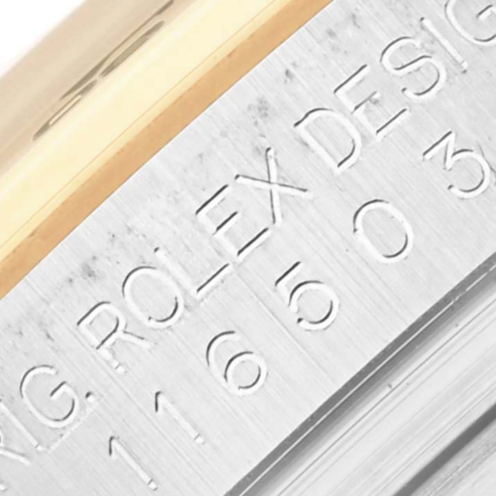 The image shows a close-up of the engraved side of a Rolex Daytona 116503 Men's Steel and Gold (two tone) Mother of Pearl Dial 116503 Men's Steel and Gold (two tone) Mother of Pearl Dial watch case, detailing model information.