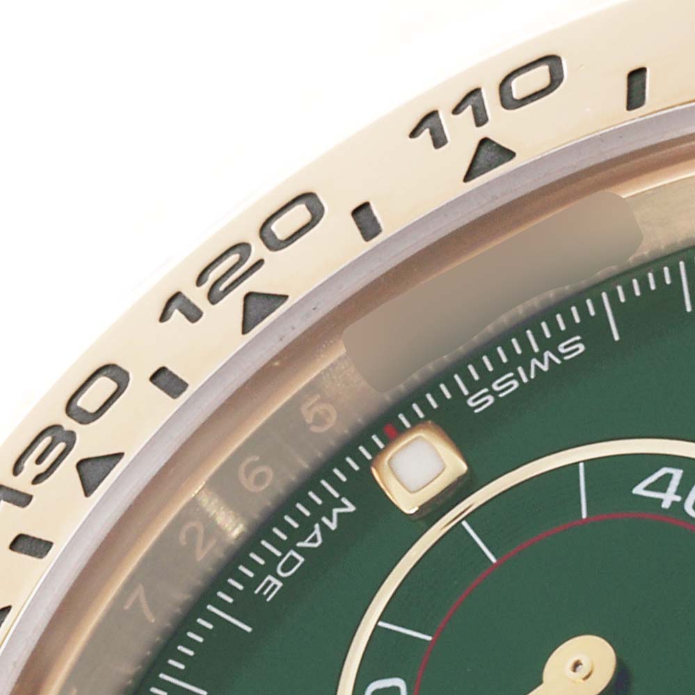The image shows a close-up of the bezel and part of the dial of a Rolex Daytona 116508 Men's Yellow Gold Green Dial 116508 Men's Yellow Gold Green Dial, highlighting the tachymetric scale.