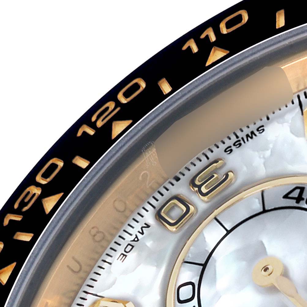 The image shows a close-up of the bezel and part of the dial of a Rolex Daytona 116518LN Men's Yellow Gold Mother of Pearl Dial 116518LN Men's Yellow Gold Mother of Pearl Dial watch.