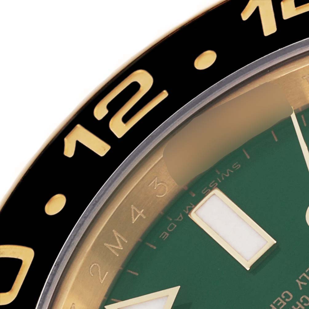 The image shows a close-up of the bezel and part of the dial of the Rolex GMT-Master 116718LN Men's Yellow Gold Green Dial 116718LN Men's Yellow Gold Green Dial watch, highlighting hour markers.