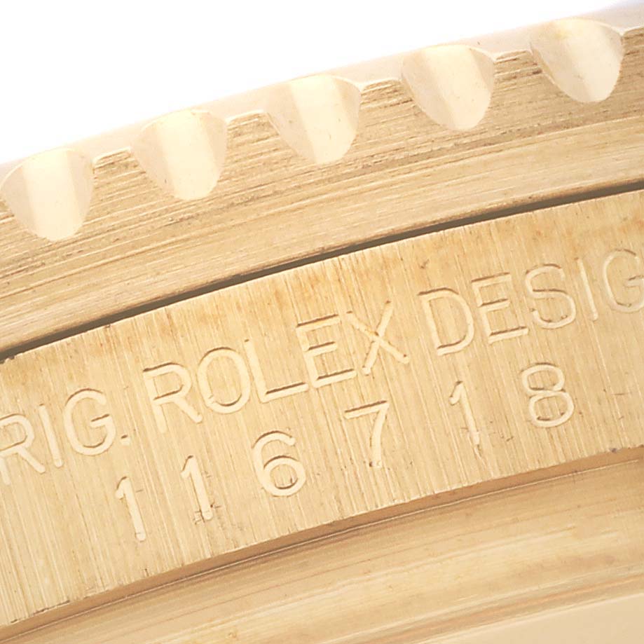 The image shows a close-up of the bezel and engraved model number on a Rolex GMT-Master 116718LN Men's Yellow Gold Green Dial 116718LN Men's Yellow Gold Green Dial watch.