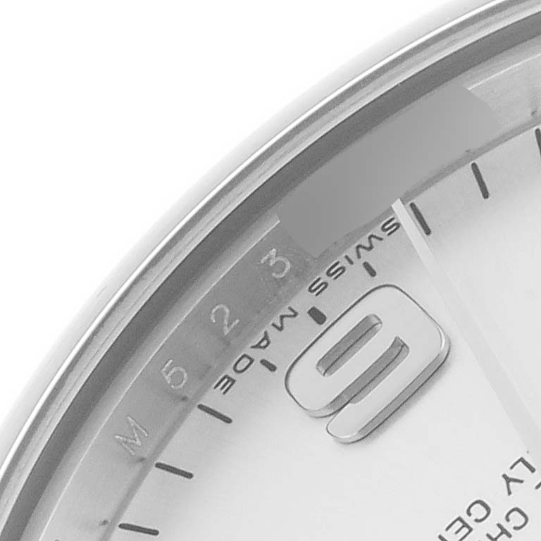 The image shows a close-up of a Rolex Mid-Size 177200 Women's Stainless Steel Silver Dial 177200 Women's Stainless Steel Silver Dial watch face, focusing on the numeral "9" and part of the bezel.