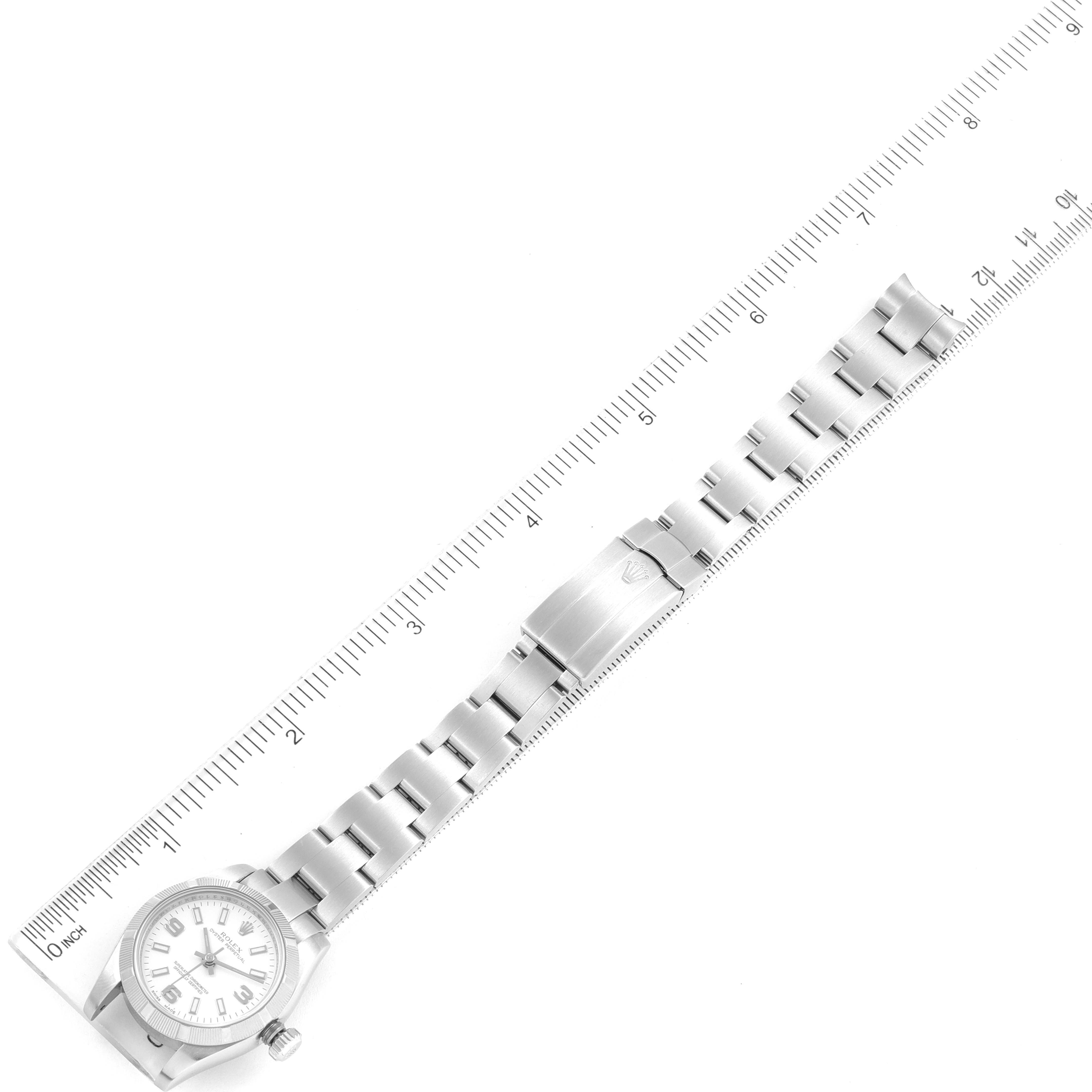 The image shows a horizontal view of a Rolex Oyster Perpetual 176210 Women's Stainless Steel White Dial 176210 Women's Stainless Steel White Dial watch, including the face, bracelet, and clasp, next to a ruler for scale.