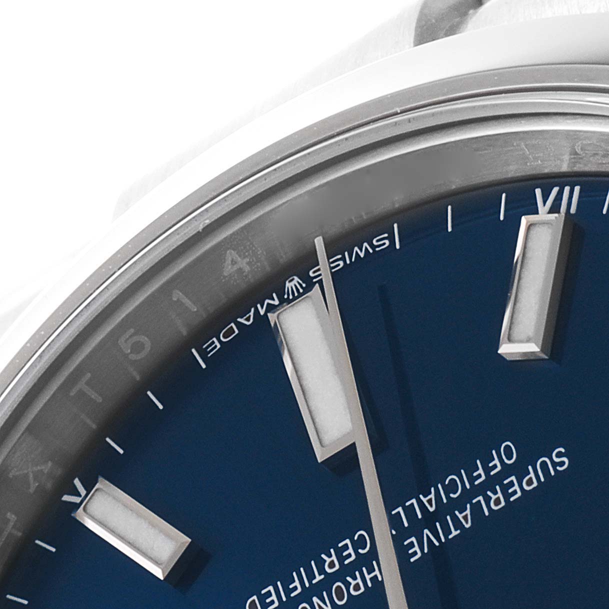 The image shows a close-up of the dial and hour markers of the Rolex Oyster Perpetual 124200 Men
s Stainless Steel Blue Dial 124200 Men
s Stainless Steel Blue Dial watch, highlighting the "Swiss Made" label.