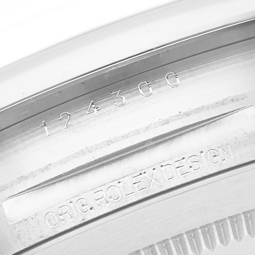 The image shows the side engraving detailing of the Rolex Oyster Perpetual 124300 Men
s Stainless Steel Black Dial 124300 Men
s Stainless Steel Black Dial watch, highlighting the model number and "Orig. Rolex Design" text.