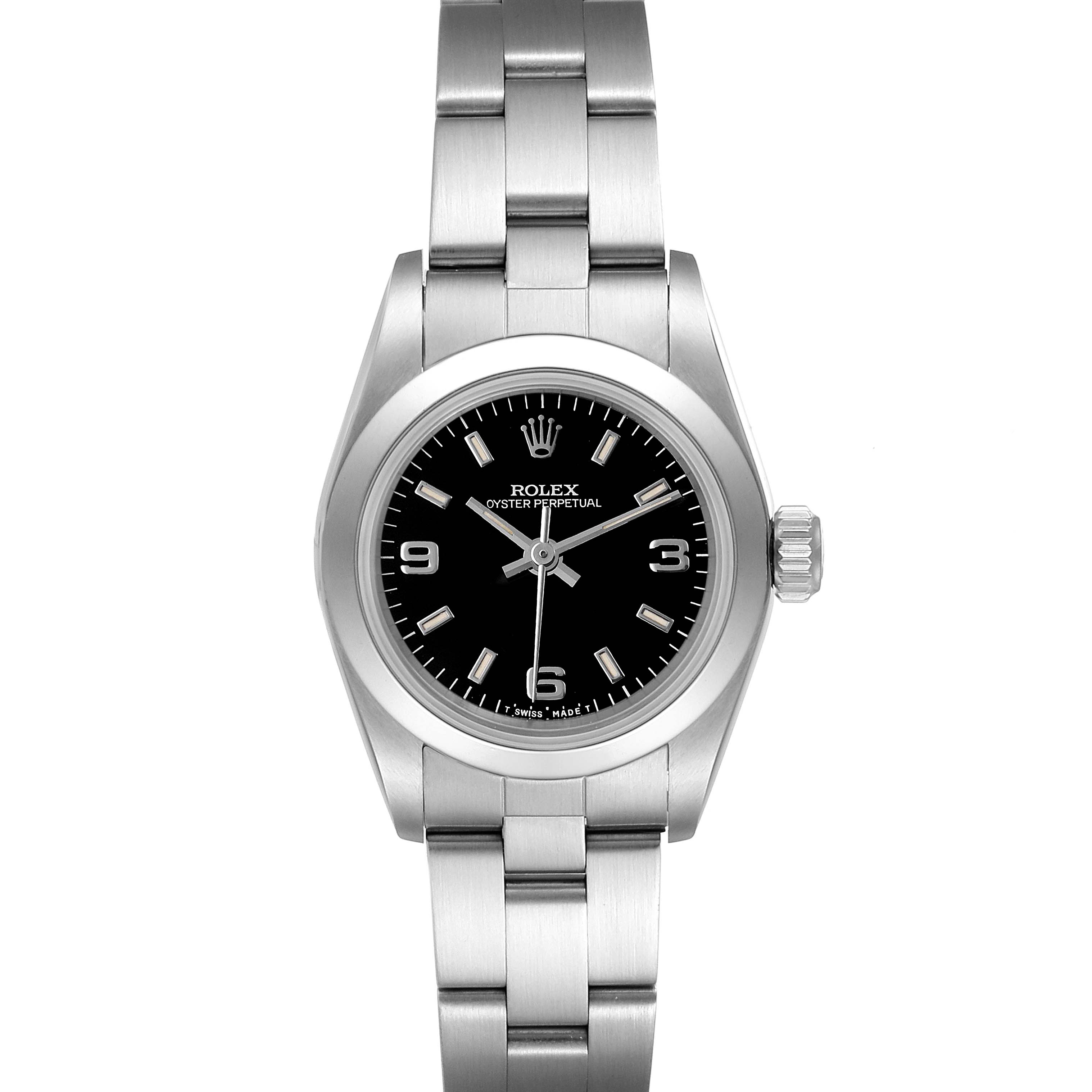 The image shows a Rolex Oyster Perpetual 67180 Women's Stainless Steel Black Dial 67180 Women's Stainless Steel Black Dial watch from a front angle, highlighting its black dial, numerals, and stainless steel bracelet.