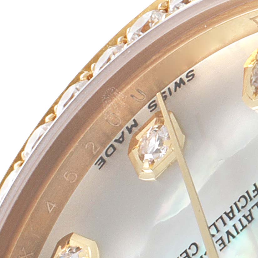 This image shows a close-up of the Rolex President 178288 Women
s Yellow Gold Mother of Pearl Dial 178288 Women
s Yellow Gold Mother of Pearl Dial model watch bezel, part of the face, and diamond hour markers.