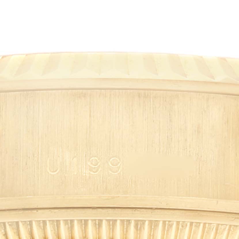 The image shows an engraved side of the bezel of a Rolex President 79178 Women
s Yellow Gold Champagne Dial 79178 Women
s Yellow Gold Champagne Dial model watch, focusing on the serial number area.