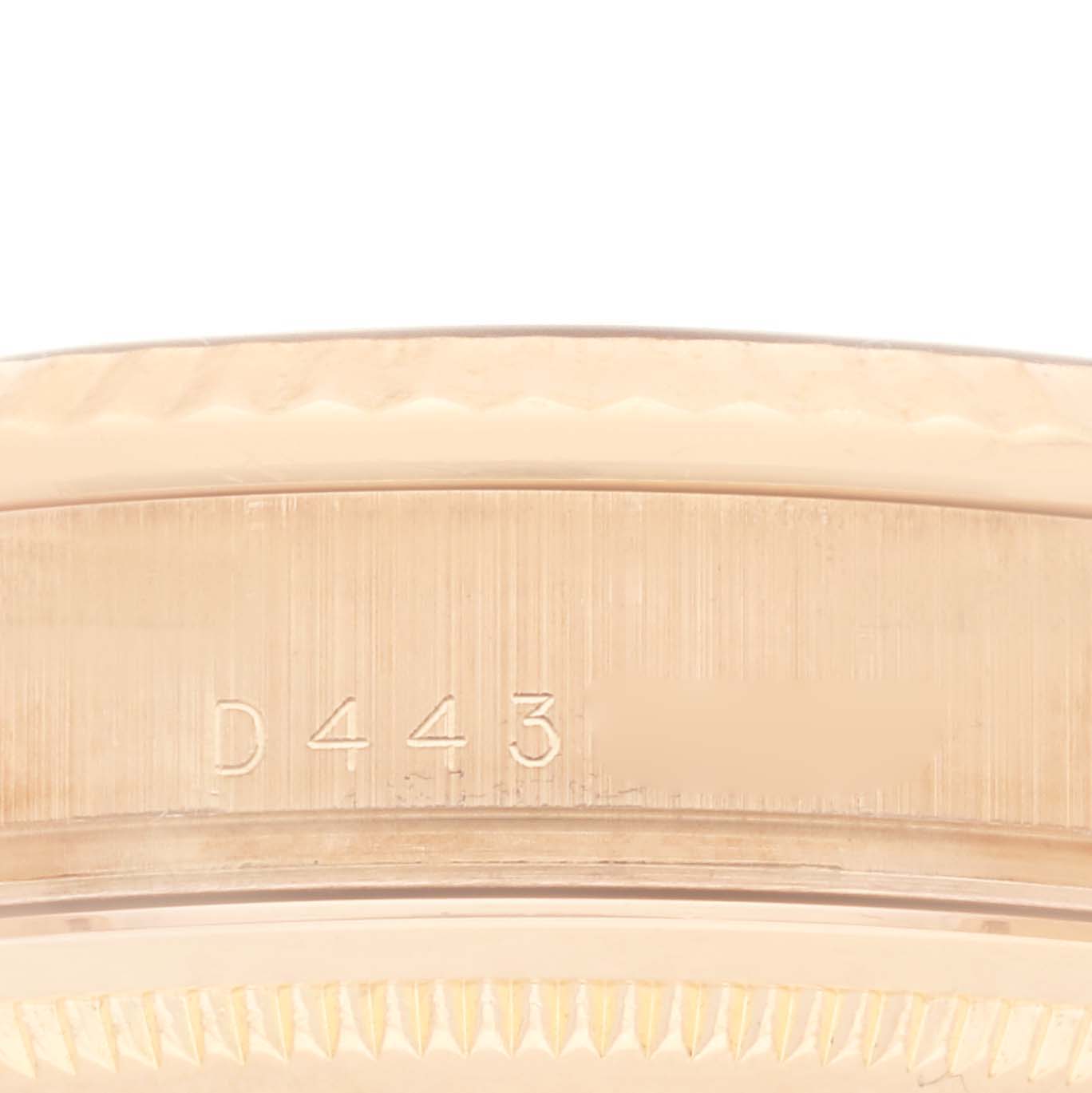 The image shows a close-up of the engraved side of the Rolex President 118235 Men
s Rose Gold Pink Dial 118235 Men
s Rose Gold Pink Dial watch case.