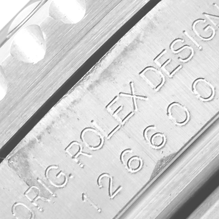 The image shows a close-up of the engraving on the side of the Rolex Sea-Dweller 126600 Men's Stainless Steel Black Dial 126600 Men's Stainless Steel Black Dial's case.