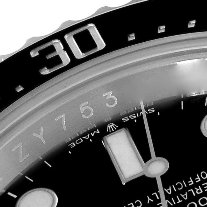 The image shows a close-up of the bezel and part of the dial of a Rolex Sea-Dweller 126600 Men
s Stainless Steel Black Dial 126600 Men
s Stainless Steel Black Dial watch, focusing on the 30-minute marker.