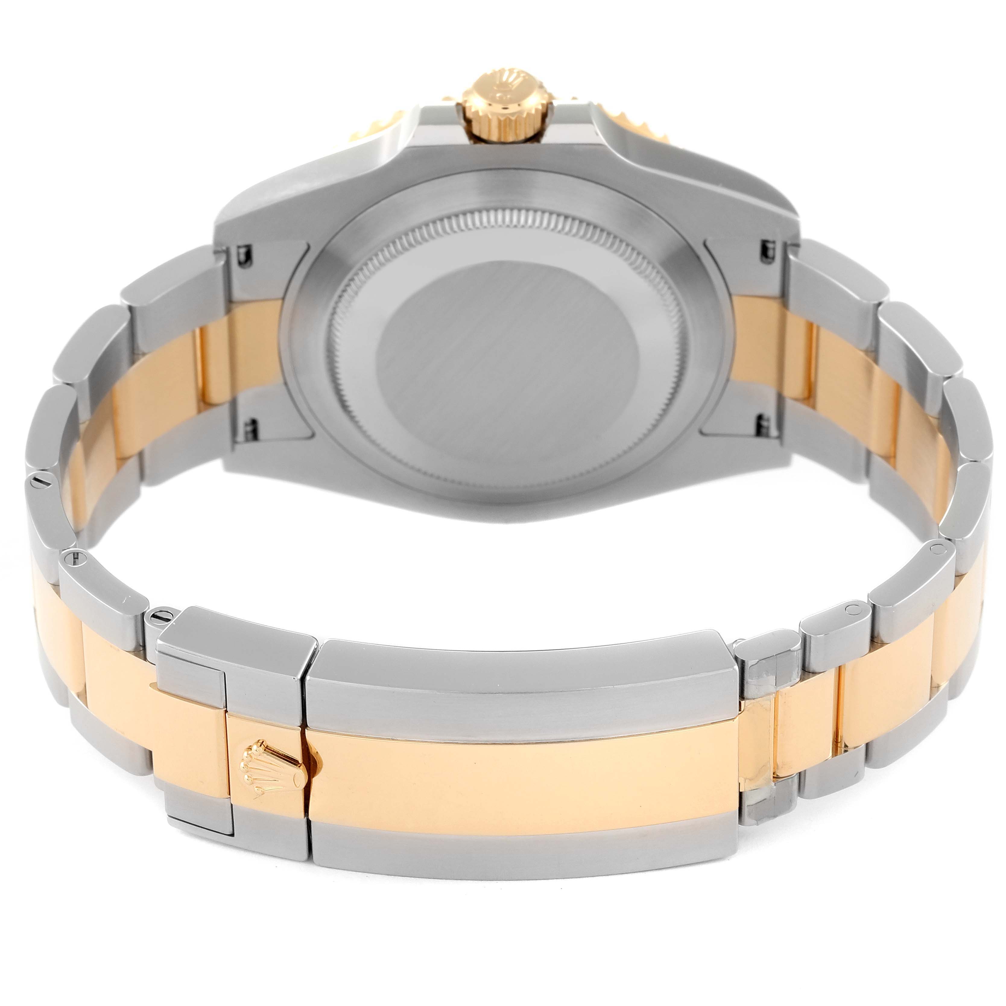 The image shows the back view of a Rolex Submariner 126613LB Men
s Steel and Gold (two tone) Blue Dial 126613LB Men
s Steel and Gold (two tone) Blue Dial watch, highlighting its case back, crown, and two-tone metal bracelet.