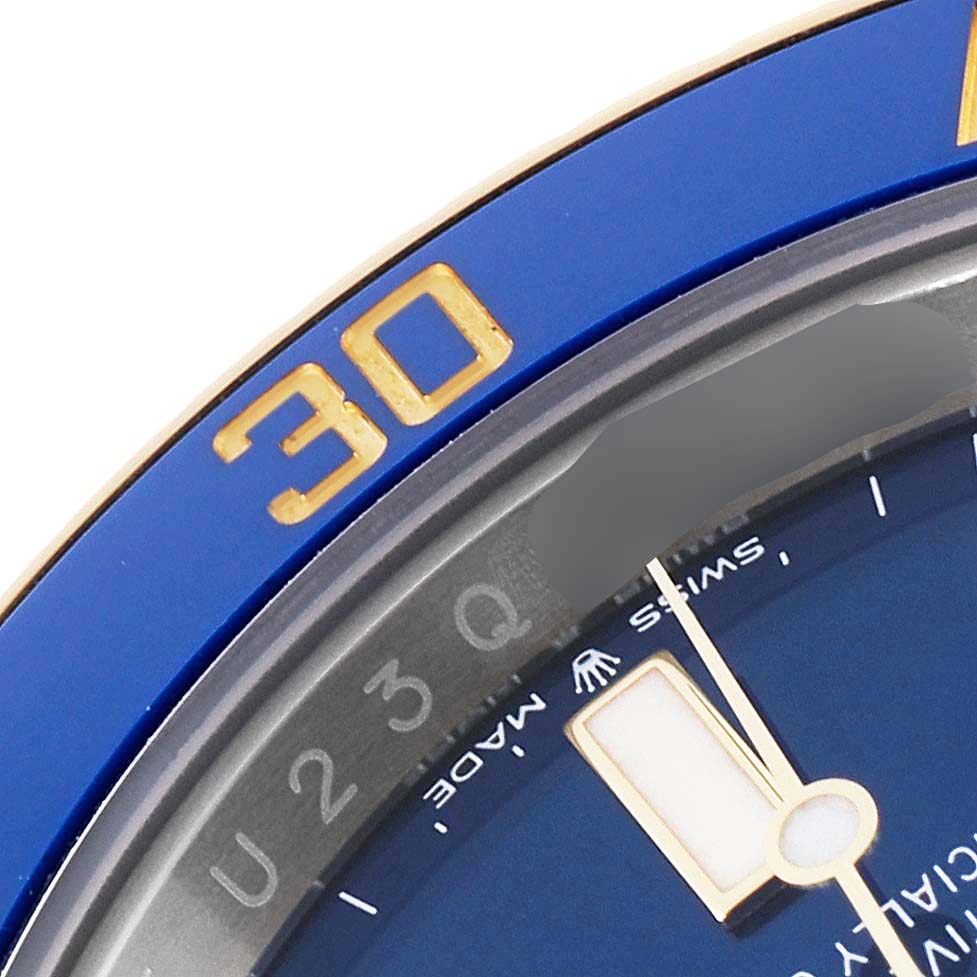 The image shows a close-up angle of the bezel and a portion of the dial of a Rolex Submariner 126613LB Men
s Steel and Gold (two tone) Blue Dial 126613LB Men
s Steel and Gold (two tone) Blue Dial watch.