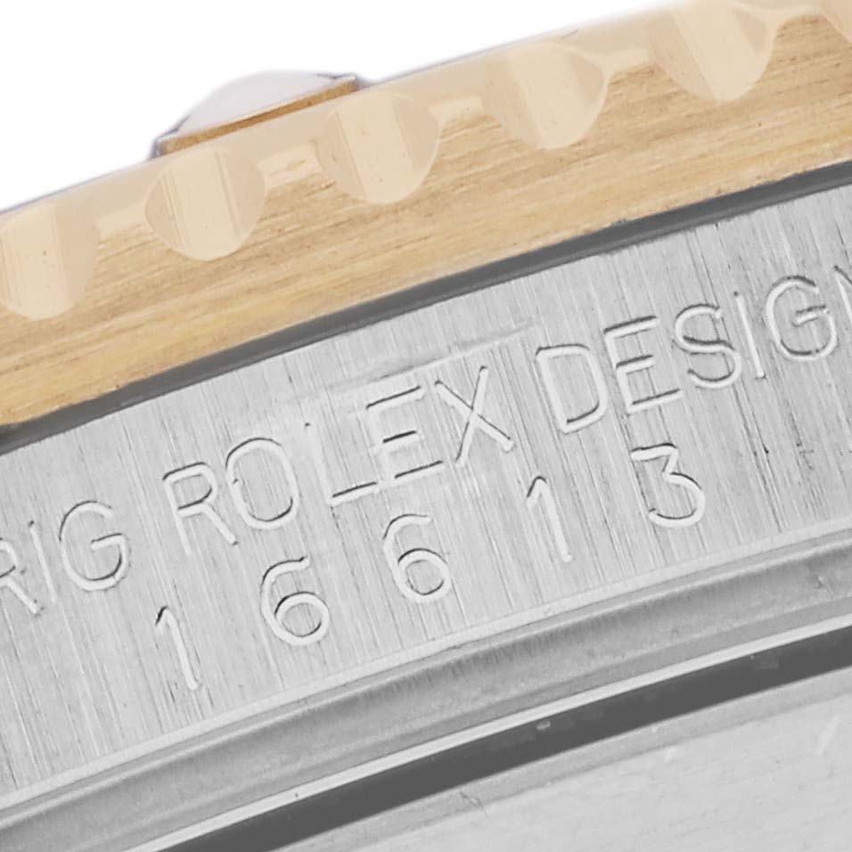 The image shows a close-up of the case side and engraved model number of a Rolex Submariner 16613 Men's Steel and Gold (two tone) Champagne Dial 16613 Men's Steel and Gold (two tone) Champagne Dial watch.