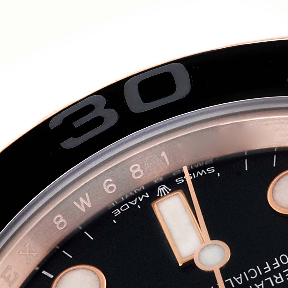 The image shows a close-up of the bezel and part of the dial of a Rolex Yacht-Master 126655 Men's Rose Gold Black Dial 126655 Men's Rose Gold Black Dial watch.