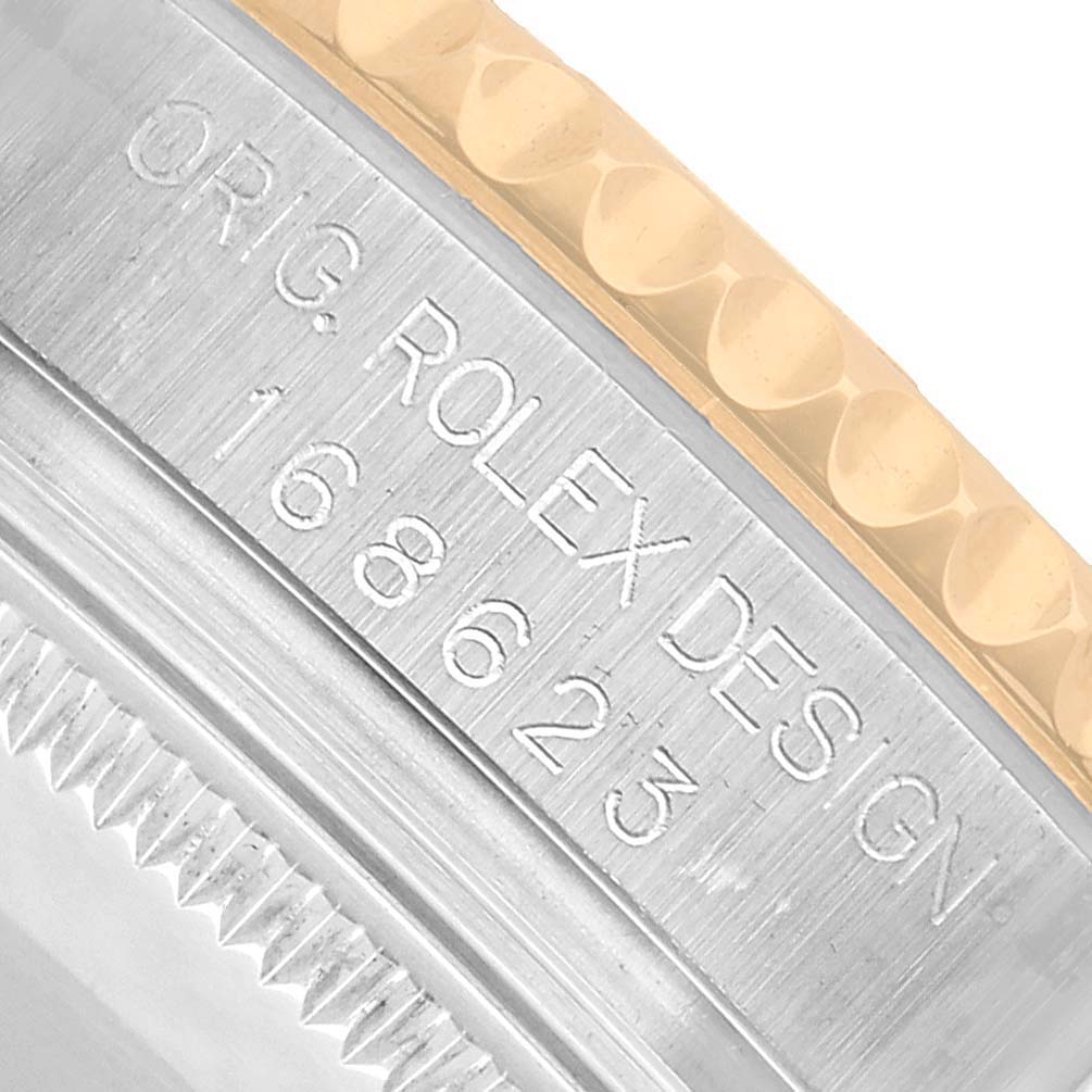The image shows a close-up of the side of a Rolex Yacht-Master 168623 Men's Steel and Gold (two tone) White Dial's case, highlighting the engraved bezel and model number.