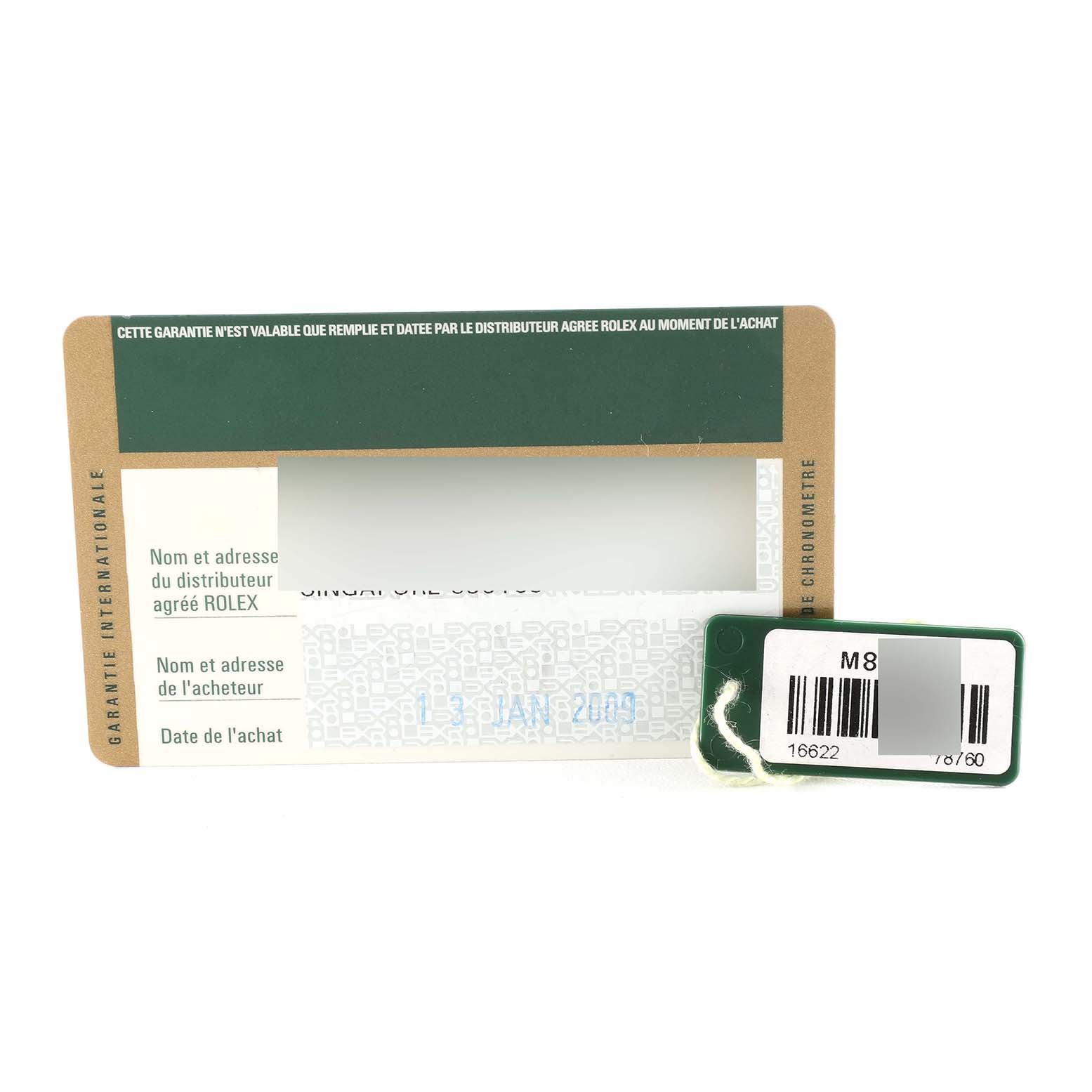 The image shows a guarantee card and a tag for a Rolex Yacht-Master 16622 Men's Stainless Steel Silver Dial 16622 Men's Stainless Steel Silver Dial watch, viewed from above.