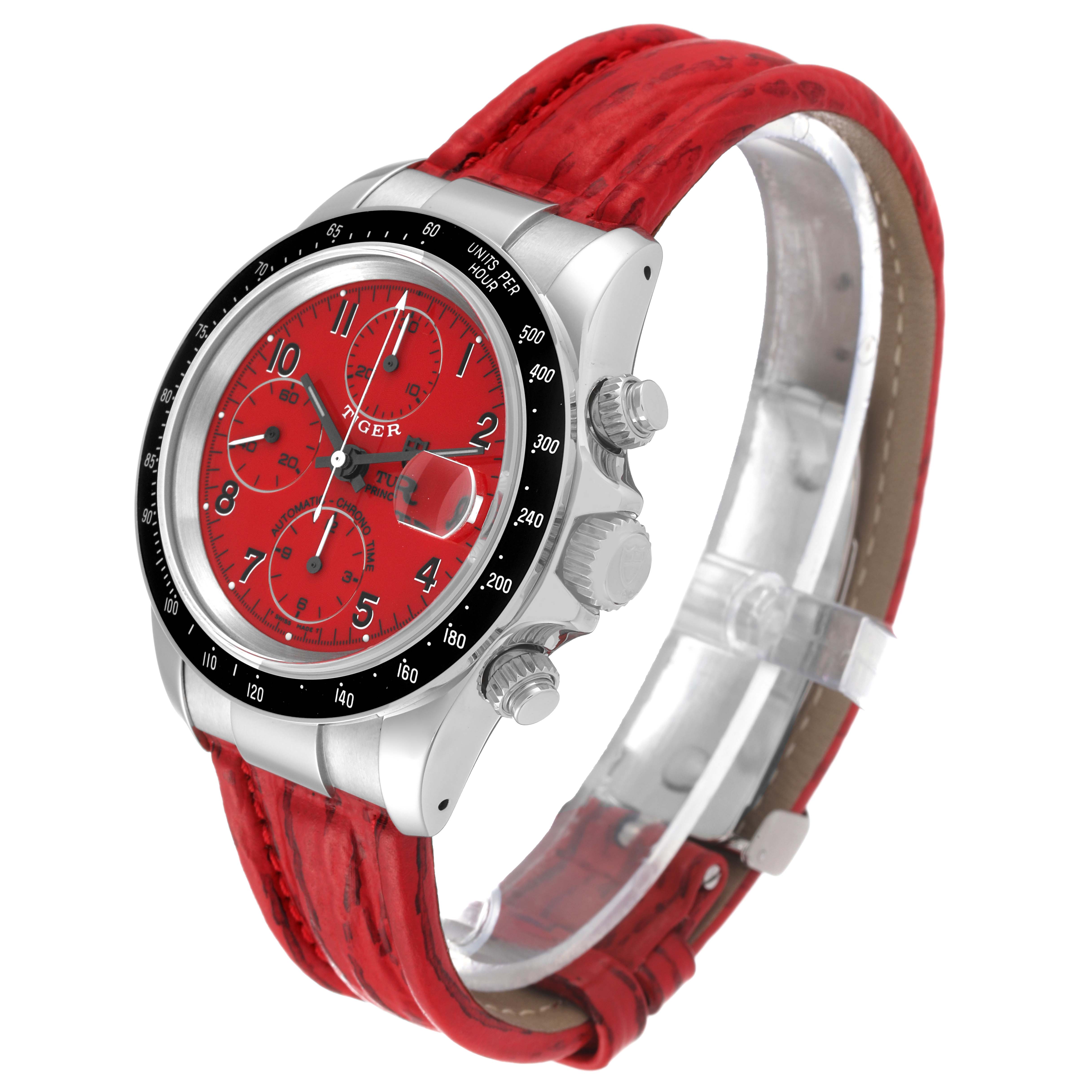 The Tudor Prince watch is shown at an angle displaying its red dial, bezel, crown, pushers, and red leather strap.