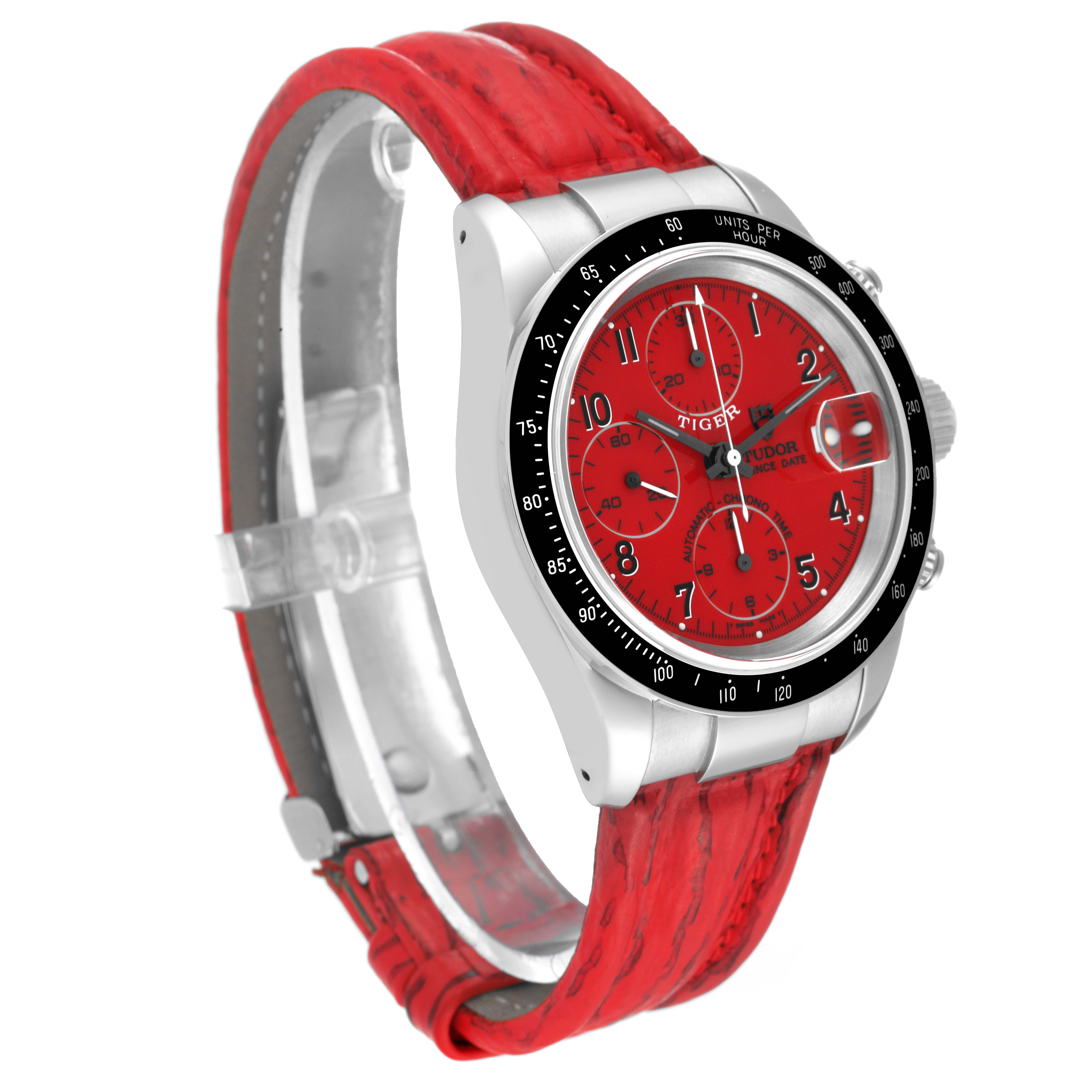 The Tudor Prince model watch is shown from a front-left angle, highlighting its red dial, black bezel, and red leather strap.