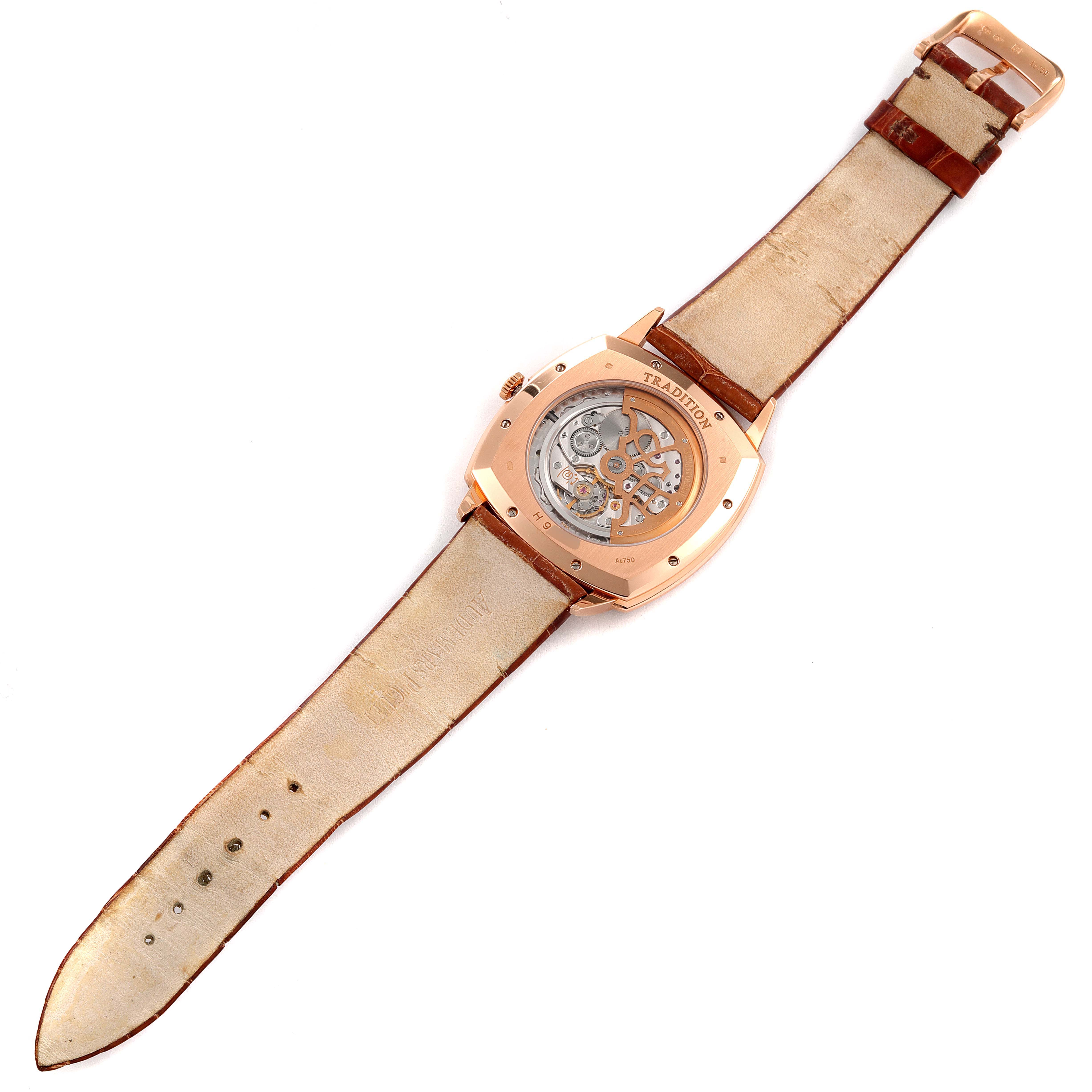 This image shows the back of a Vintage Audemars Piguet watch, featuring its leather strap and exposed mechanical movement.