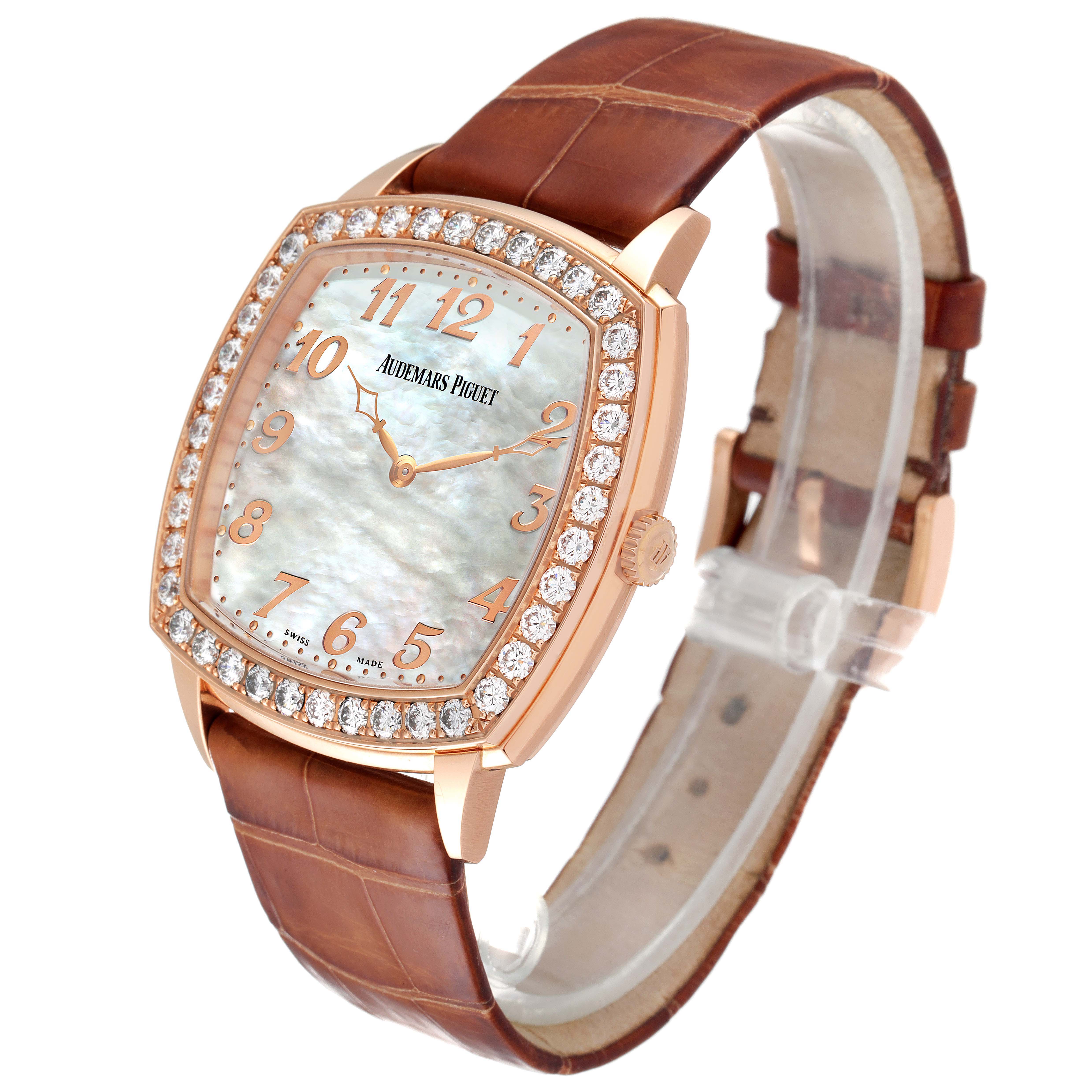This Vintage Audemars Piguet watch is shown at a slight angle, displaying its diamond-studded bezel, brown leather strap, and mother-of-pearl dial.