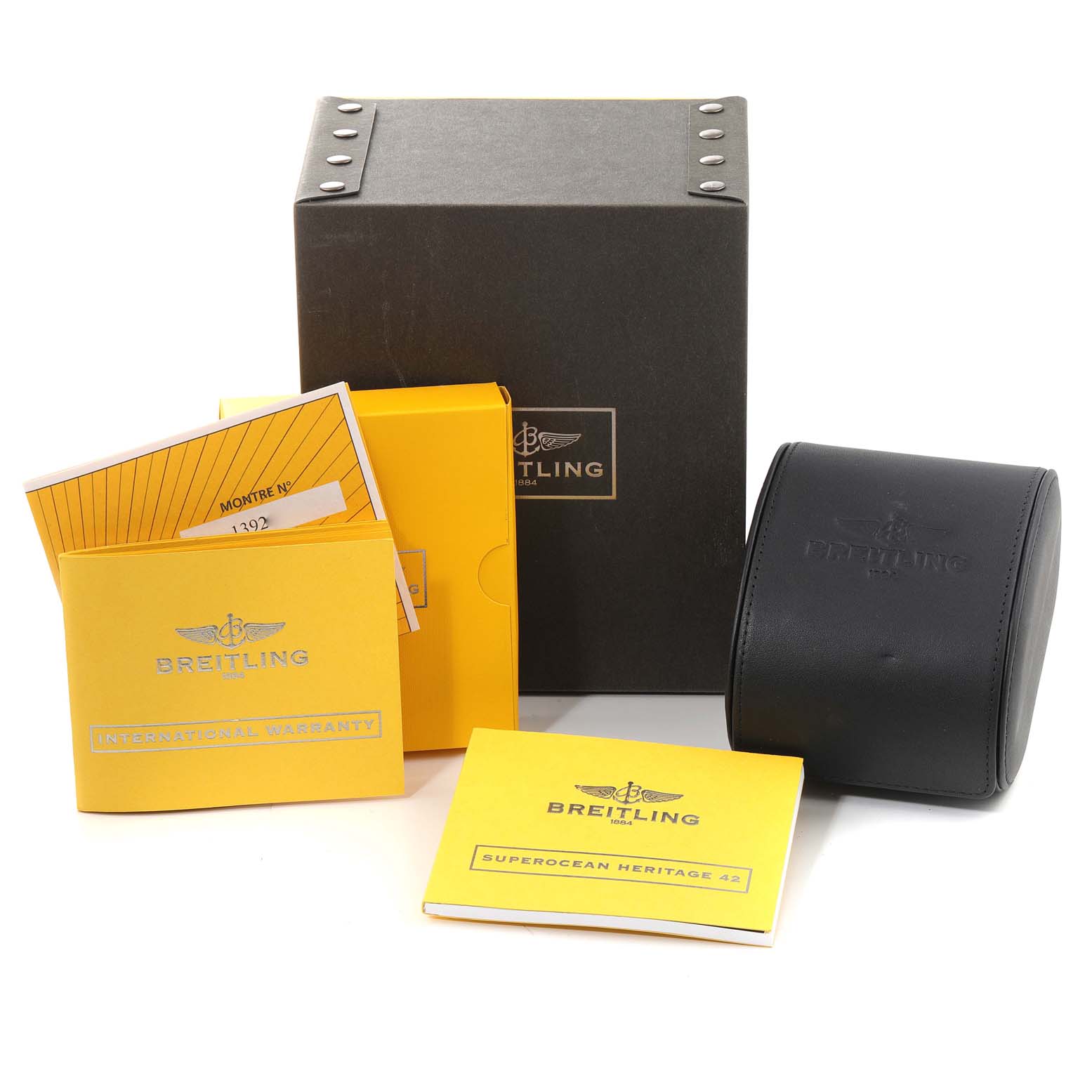 The image shows a Breitling Superocean A17321 Men's Stainless Steel Silver Dial A17321 Men's Stainless Steel Silver Dial watch box, warranty booklets, and a watch case from a front angle.