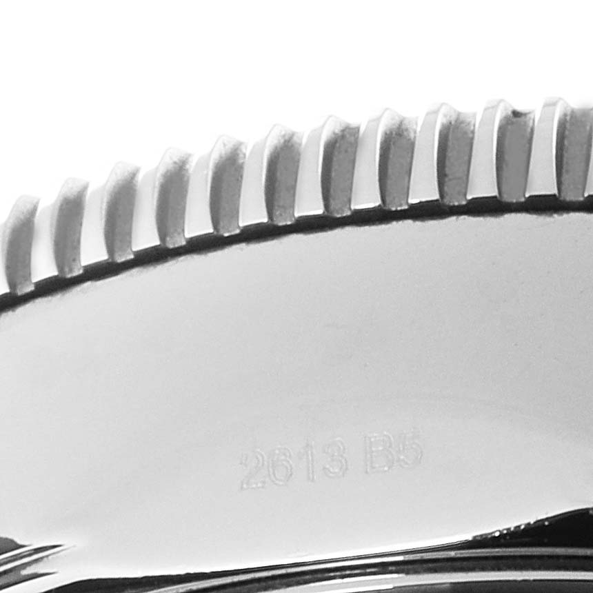 This image shows a close-up of the bezel edge and part of the casing of a Breitling Superocean U23370 Men
s Steel and Gold (two tone) Black Dial U23370 Men
s Steel and Gold (two tone) Black Dial watch, including the engraved serial number.