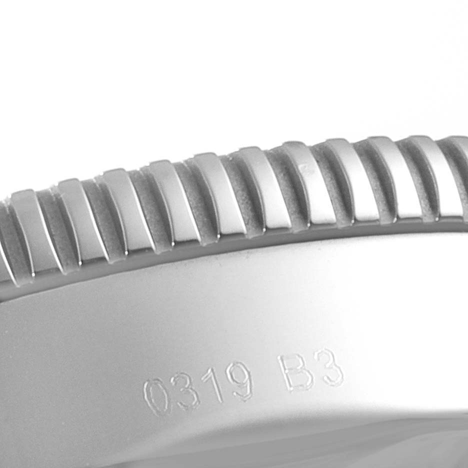 This is a close-up of the bezel and part of the case of the Breitling Superocean AB2030 Men's Stainless Steel Black Dial AB2030 Men's Stainless Steel Black Dial watch, showing the serial number.
