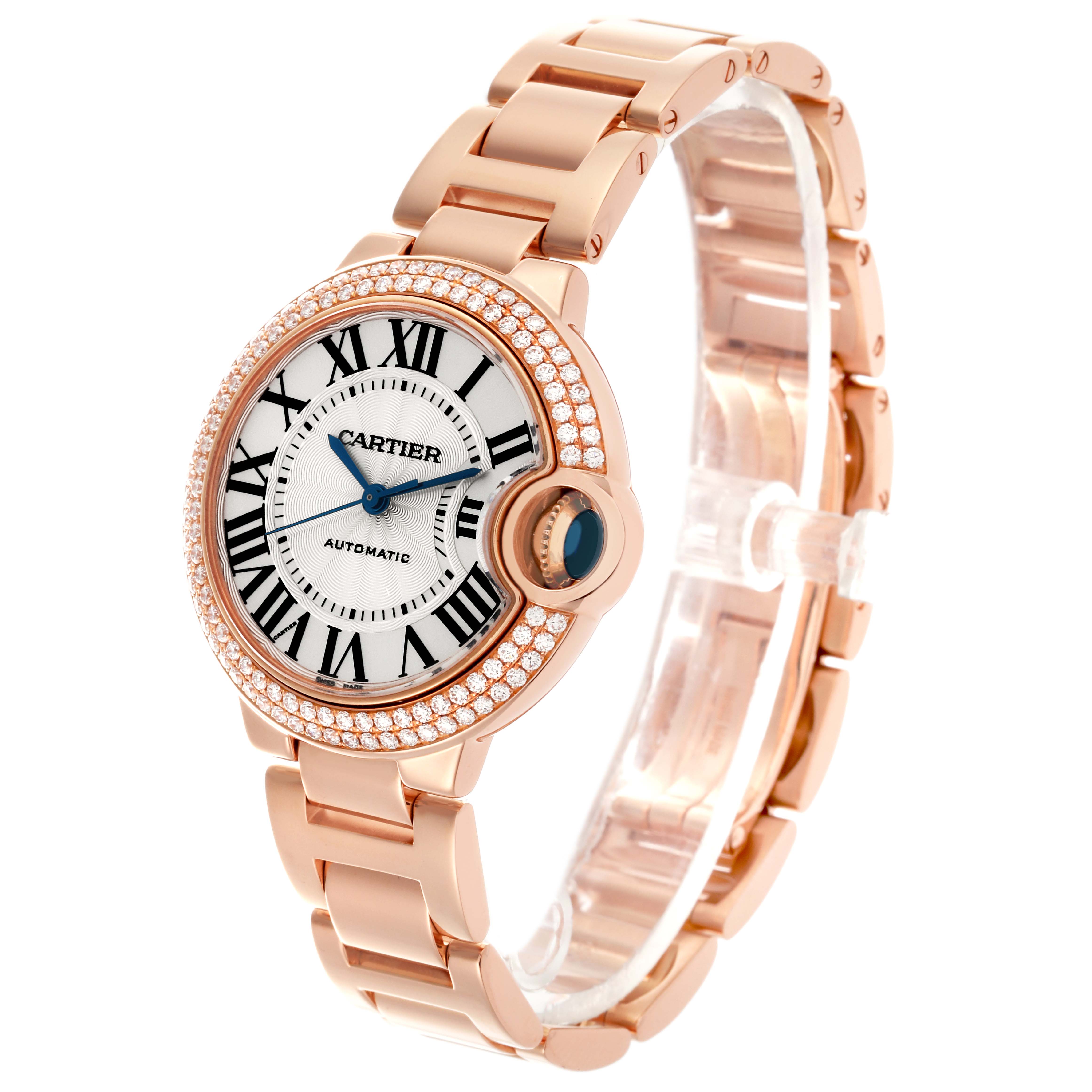 The Cartier Ballon Bleu WE902064 Men
s Rose Gold Silver Dial WE902064 Men
s Rose Gold Silver Dial watch is shown at a three-quarter angle, highlighting its face, bezel with diamonds, and bracelet.