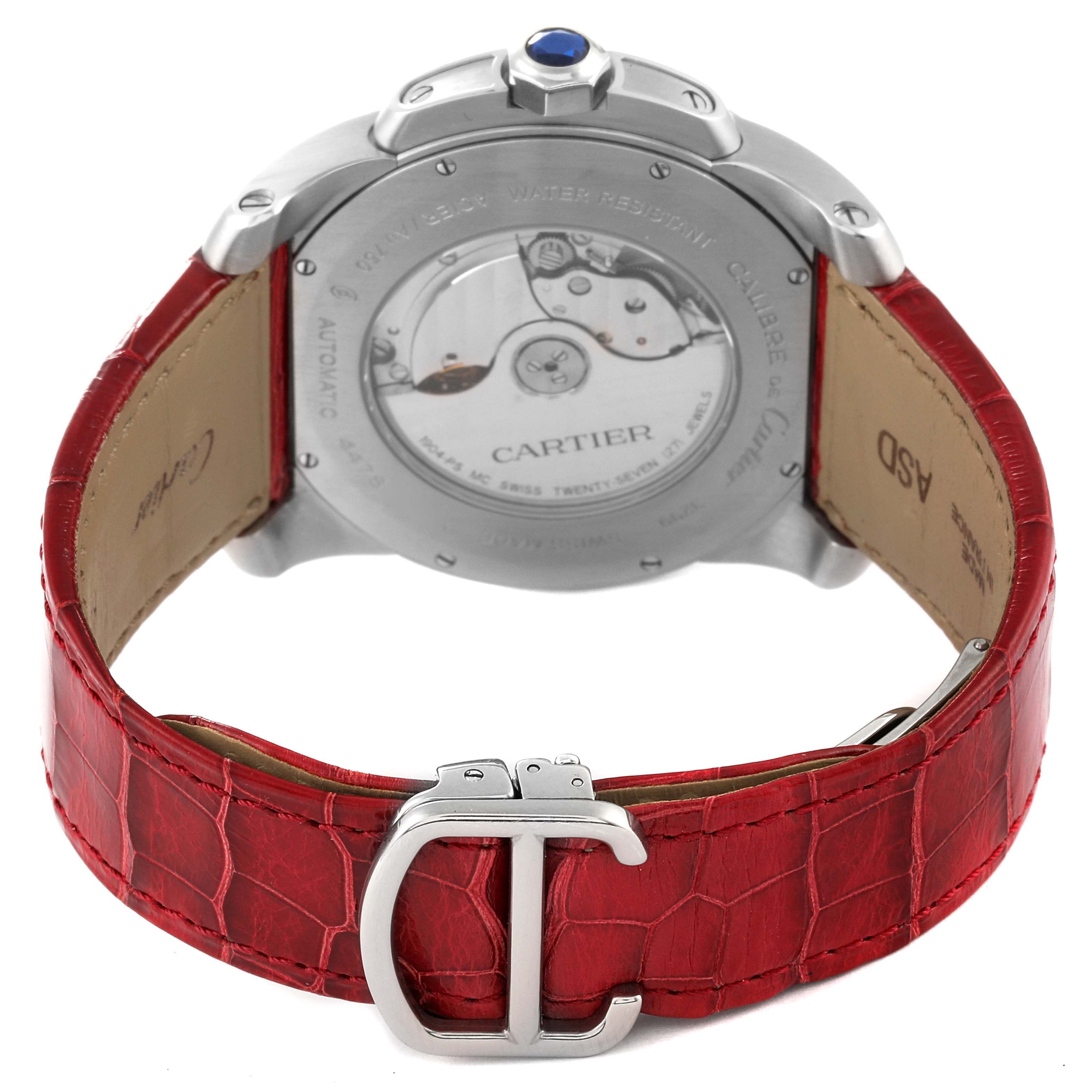 The image shows the back of a Calibre de Cartier watch by Cartier, with a red leather strap and a metal buckle.