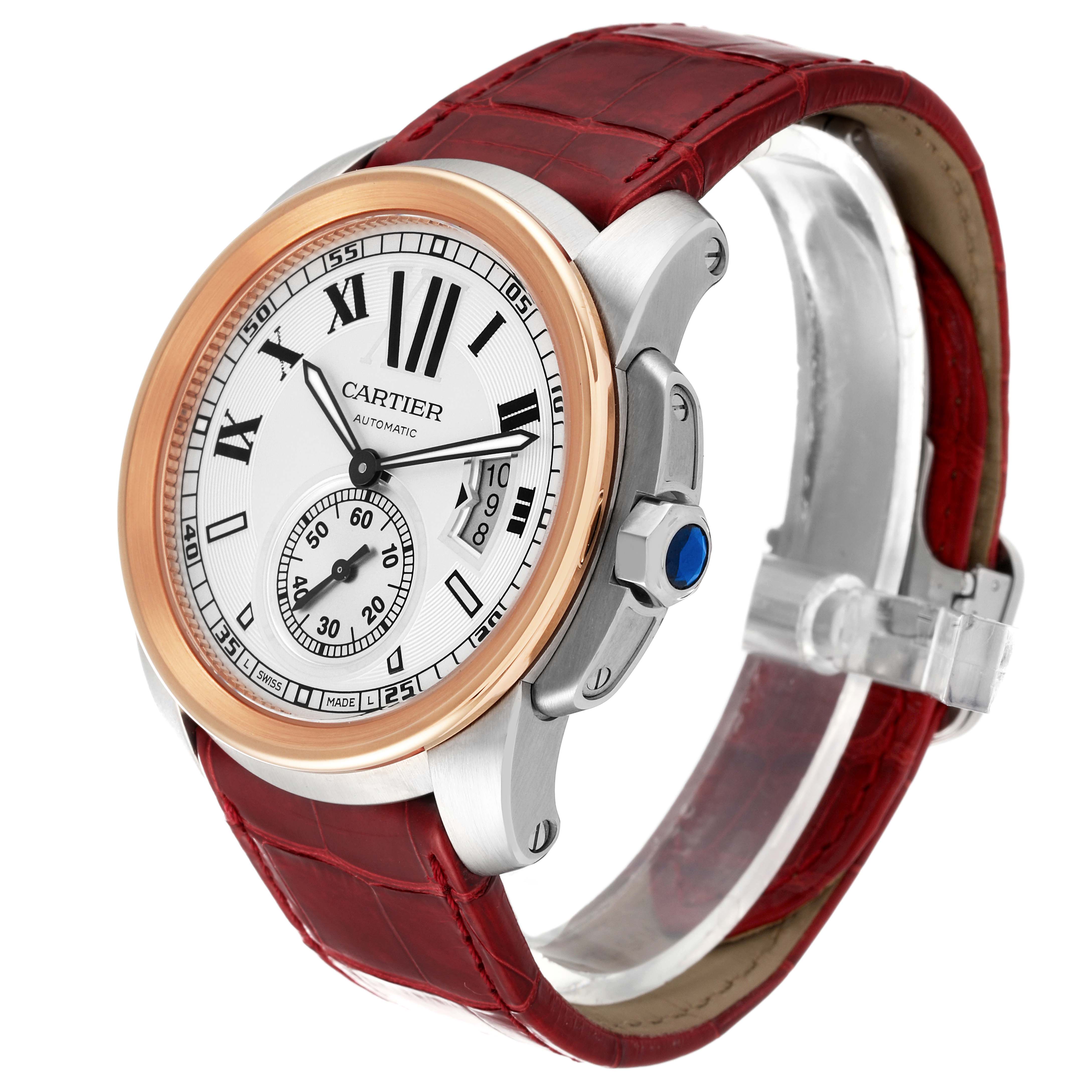 The image shows a Calibre de Cartier watch by Cartier at a three-quarter angle, highlighting the dial, crown, and red leather strap.