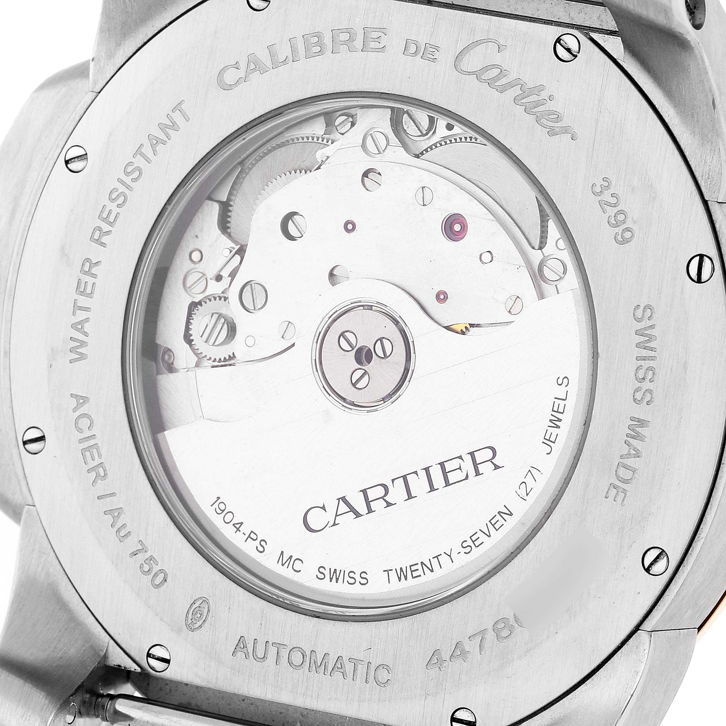 The image shows the back side of the Calibre de Cartier model by Cartier, revealing the automatic movement and internal mechanics.