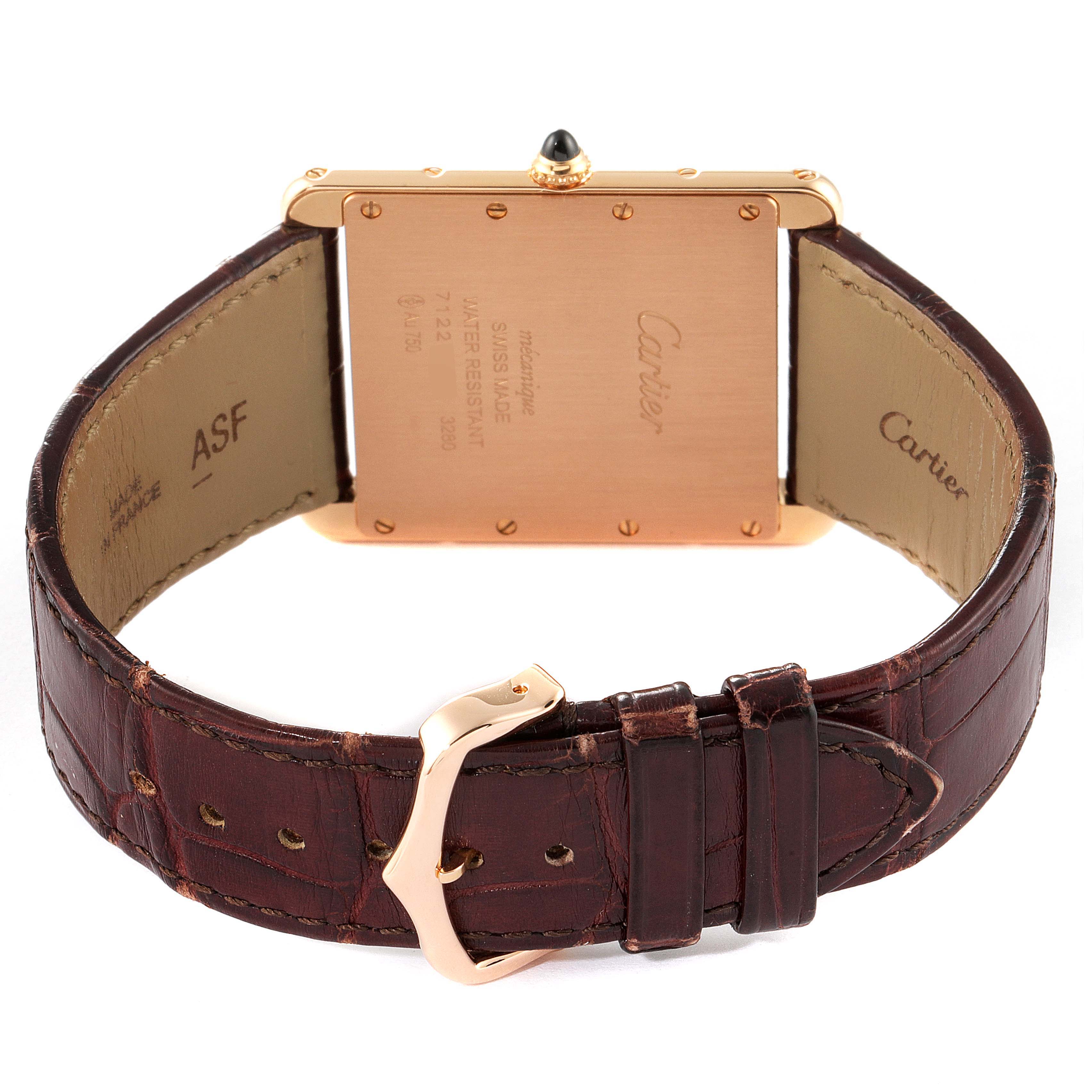The image shows the Tank Louis Cartier watch from a rear angle, highlighting the case back and leather strap with a buckle.