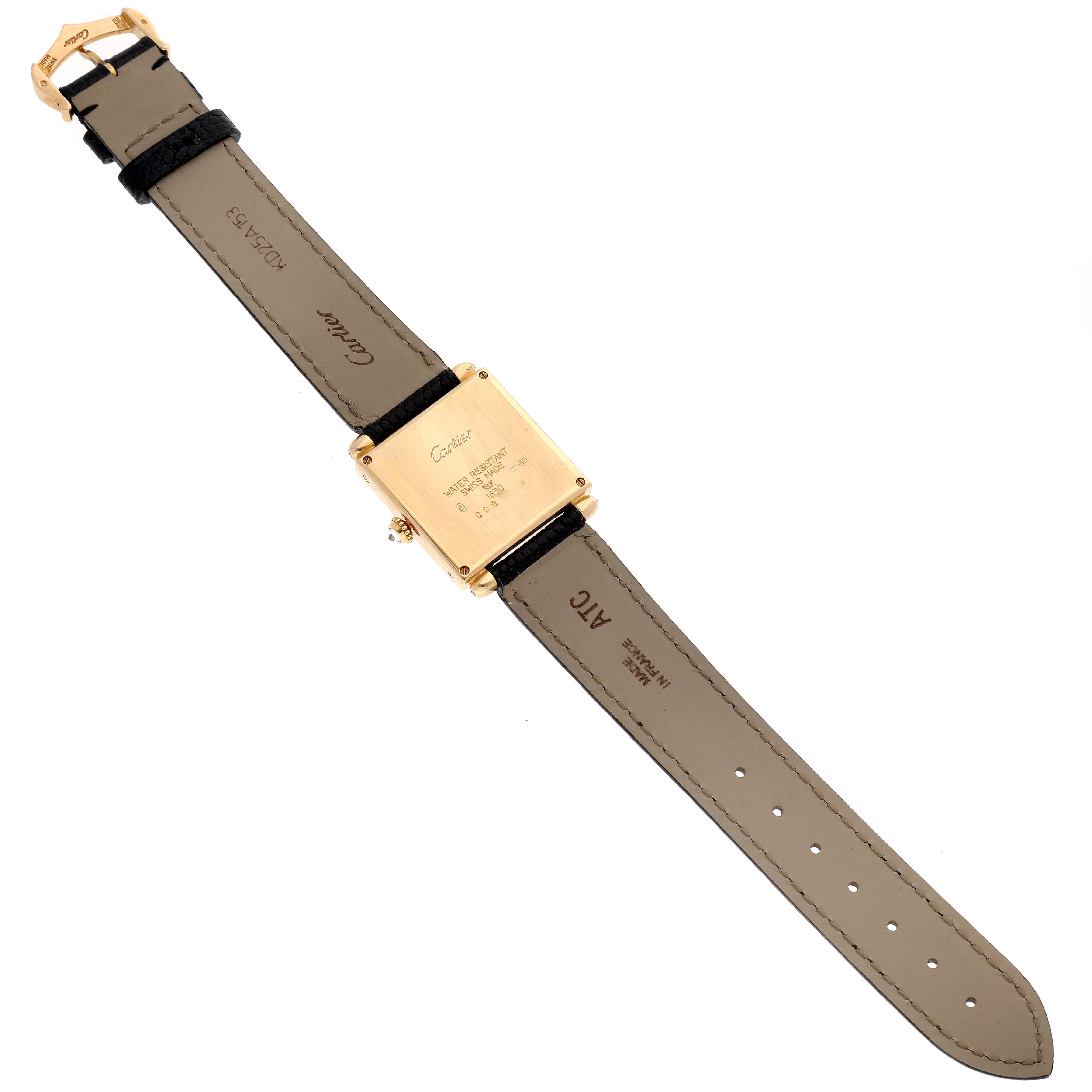 The image shows the back view of a Tank Obus model watch by Cartier, displaying the watch case and leather straps.