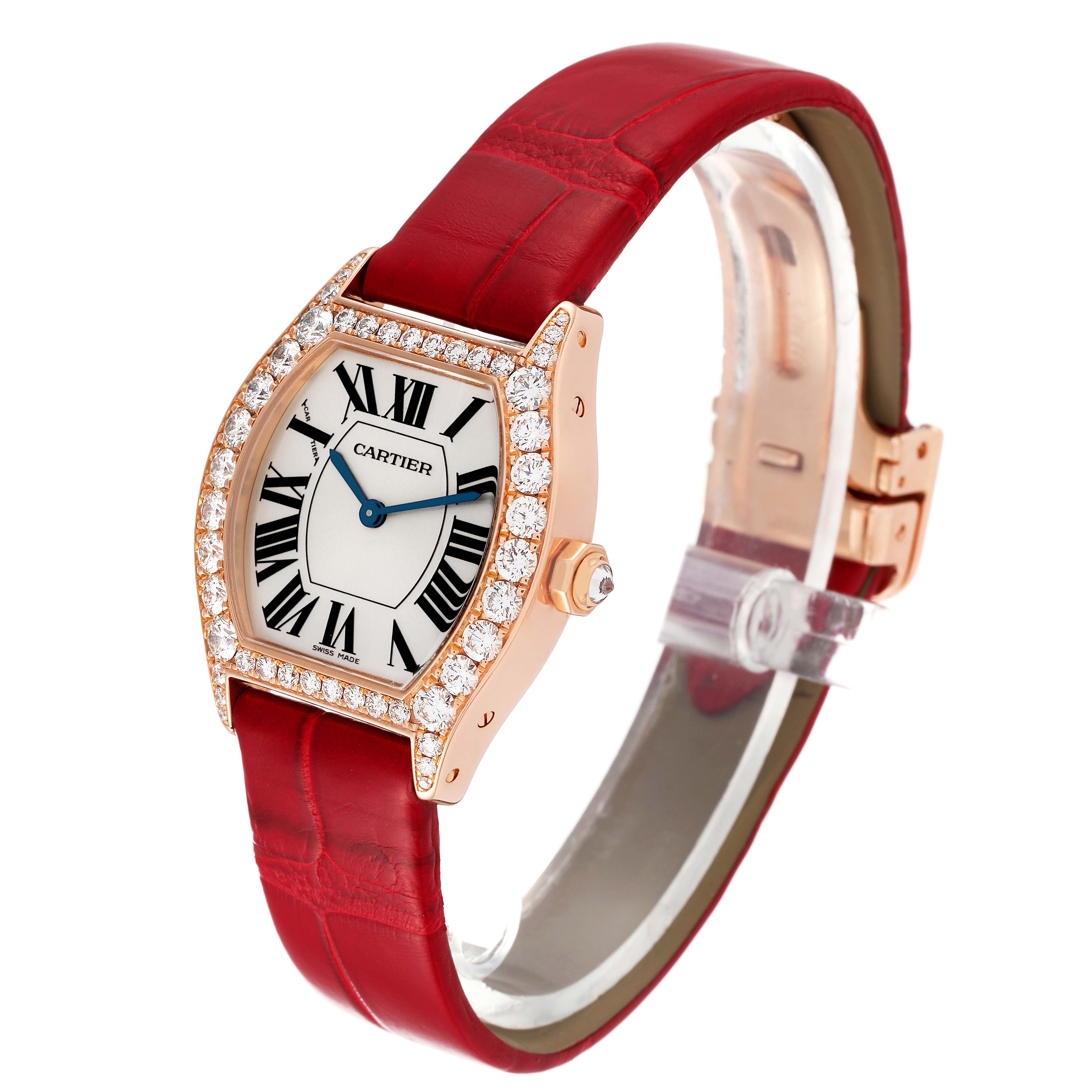 This image shows a Cartier Tortue WA507031 Women's Rose Gold Silver Dial WA507031 Women's Rose Gold Silver Dial watch at a side-angle, highlighting its face, red strap, and diamond-encrusted bezel.